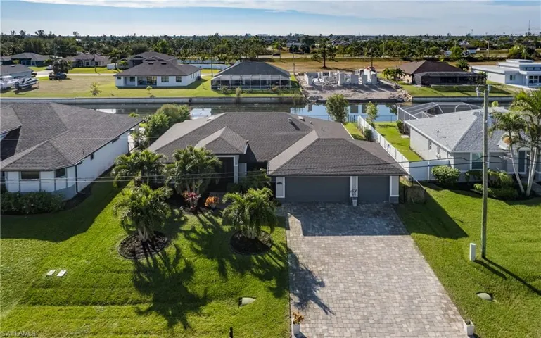Birds eye view of property with a canal view