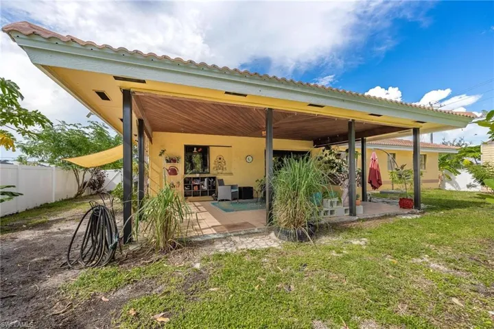 Rear view of house featuring a lawn and a patio area
