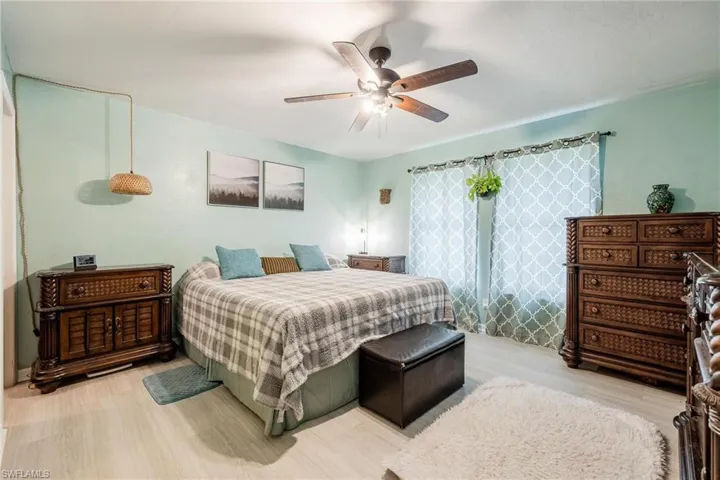 Bedroom with ceiling fan and light hardwood / wood-style flooring
