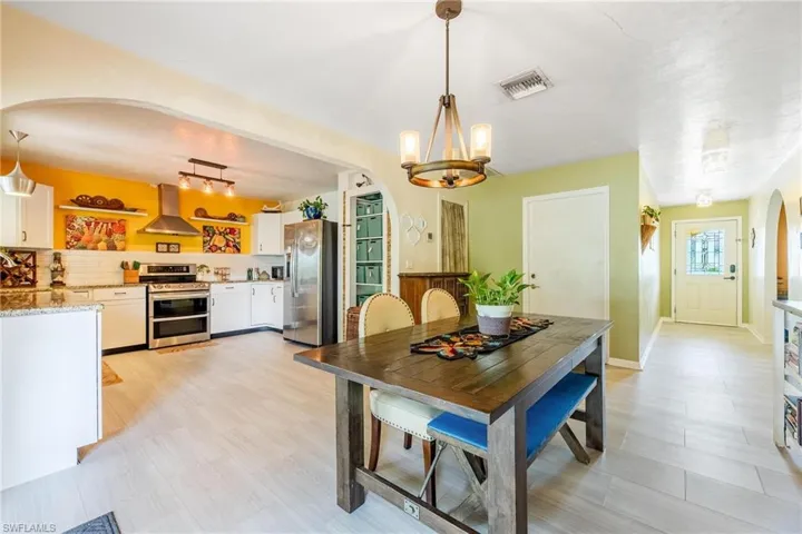 Dining space featuring light hardwood / wood-style flooring and an inviting chandelier