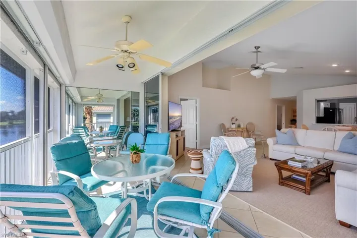 Screened-in lanai featuring large-format tile flooring and opening into the interior via expansive sliding glass doors