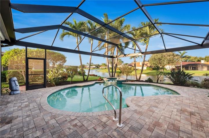 Lanai with paver pool decking and screen enclosure with two window panes.