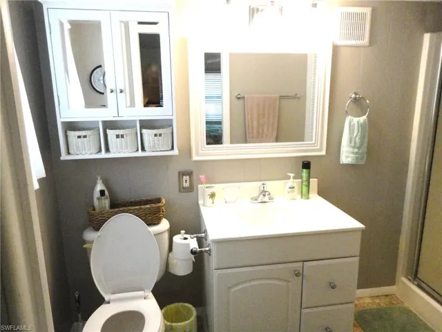 Master Bathroom featuring vanity, toilet, and walk in shower