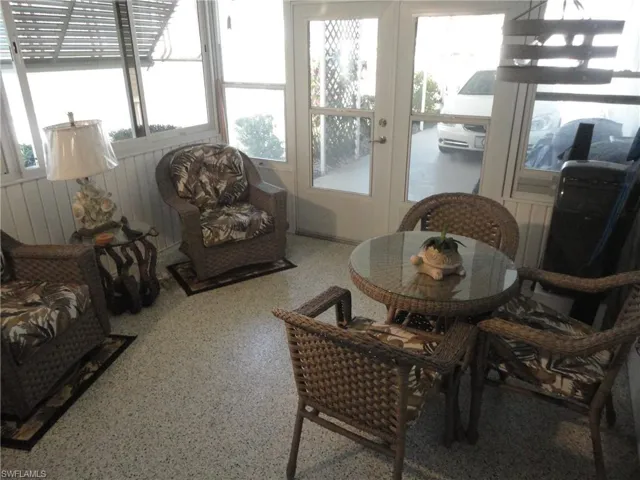 Sunroom / solarium with plenty of natural light and french doors