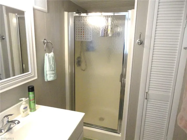 Master Bathroom featuring vanity and a shower with shower door