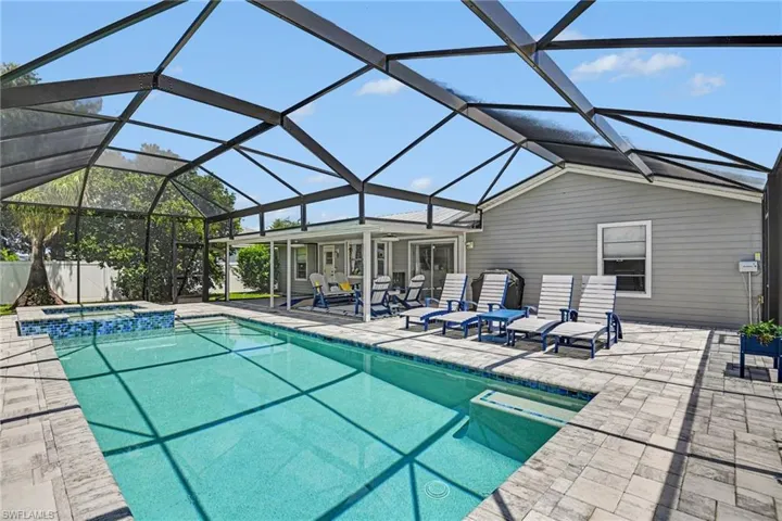 Lots of comfortable lanai seating for pool day relaxation.