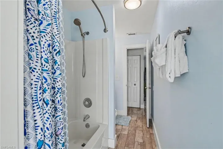 Hallway bathroom near two bedrooms.