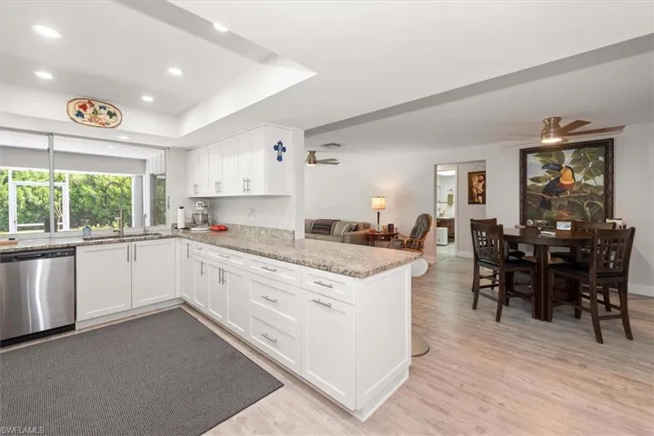Modern kitchen featuring white cabinetry, light-toned countertops, and stainless steel appliances