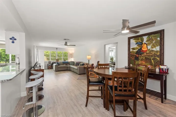 Open-concept living space featuring wood-finish flooring, recessed lighting, and multiple ceiling fans