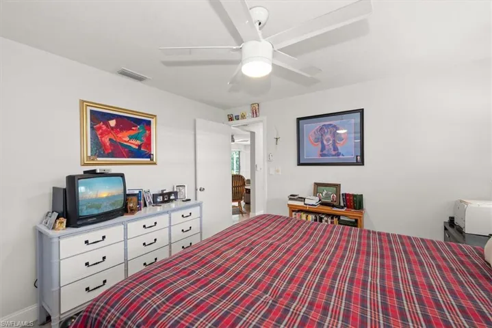 White walls and a ceiling fan with integrated lighting