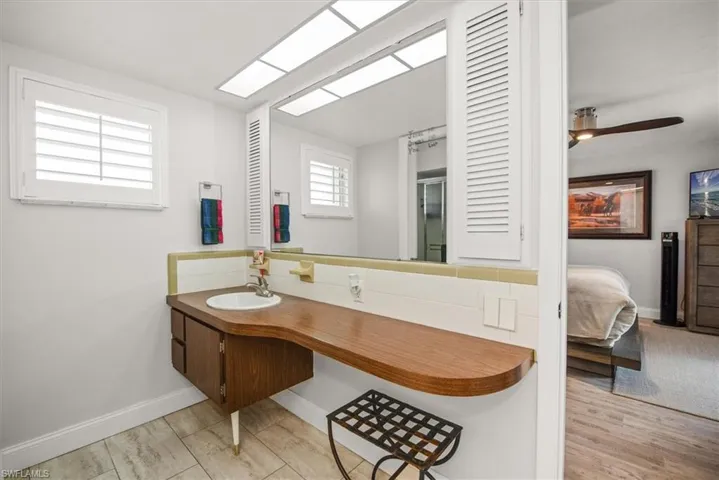 Vanity with a wood-finish countertop and integrated sink basin