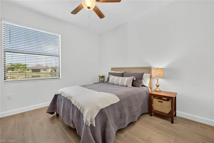 Bedroom with light wood-type flooring and a ceiling fan