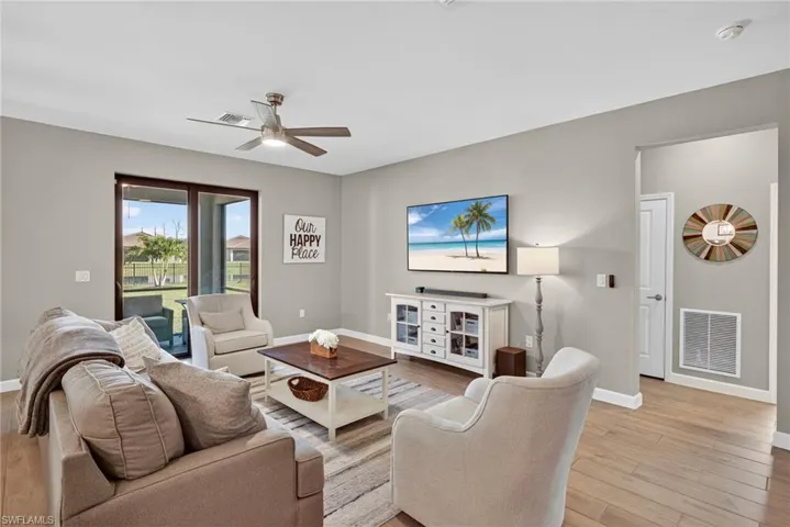 Living room with light wood-style floors and a ceiling fan