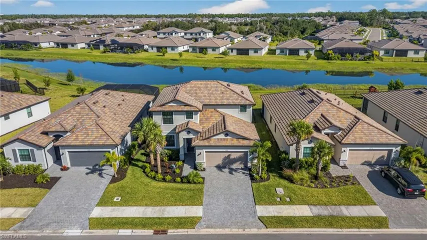 Aerial perspective of suburban area featuring a nearby body of water