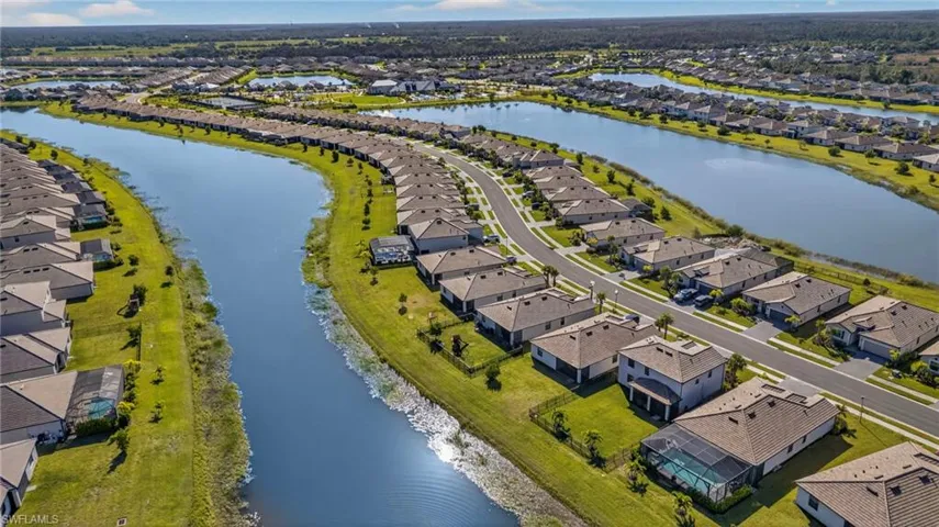 Aerial view of residential area featuring a nearby body of water
