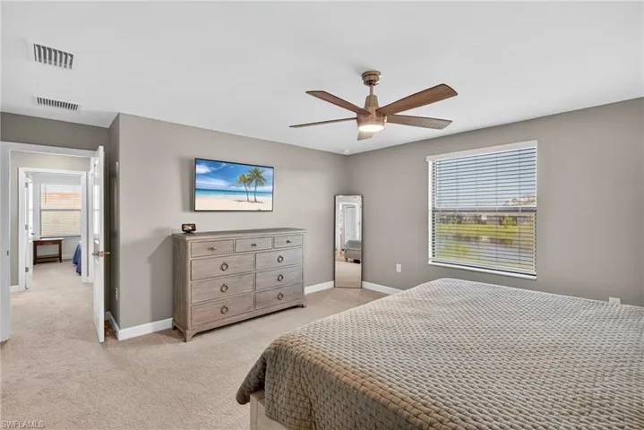 Bedroom with light carpet and ceiling fan
