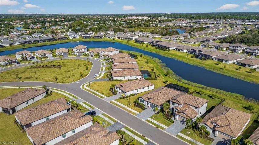View of property location featuring a nearby body of water and nearby suburban area