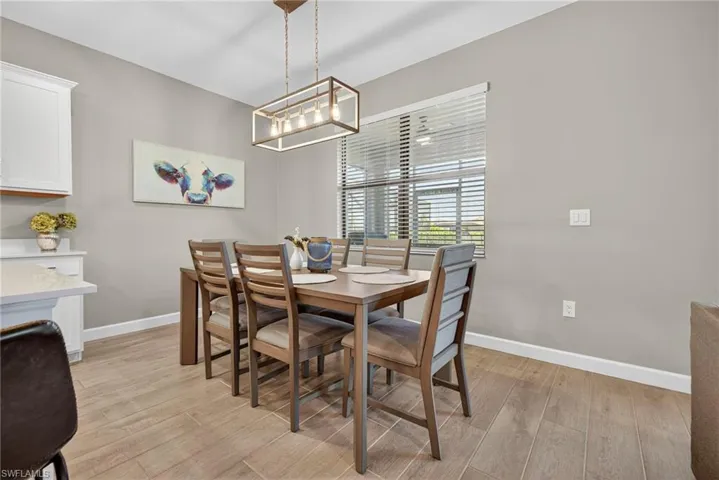 Dining room with light wood-type flooring and baseboards