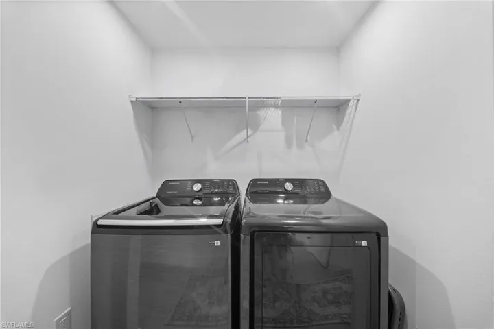 Laundry alcove featuring a wall-mounted wire storage shelf