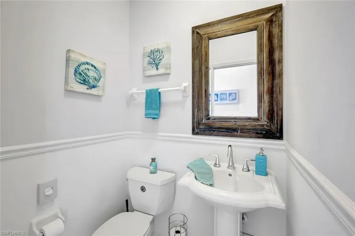 Half bath featuring a sink and toilet