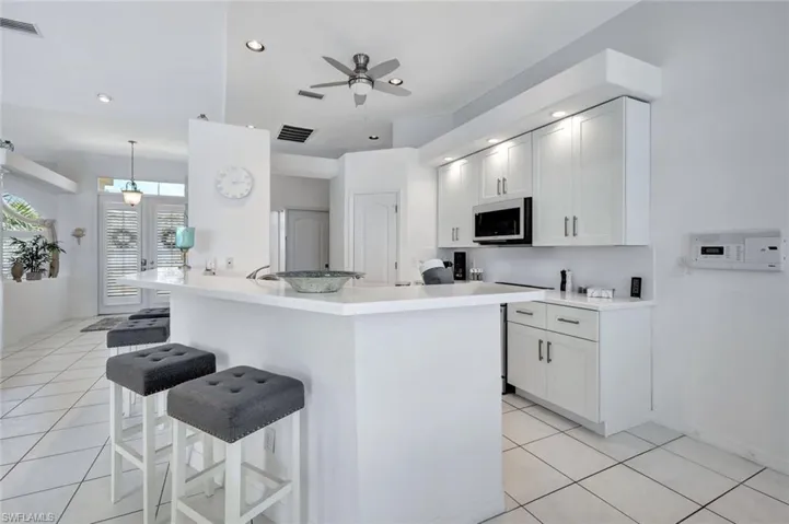 Kitchen featuring breakfast bar