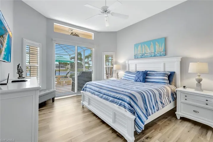 2nd Bedroom featuring a ceiling fan, light wood-style flooring, and access to pool area