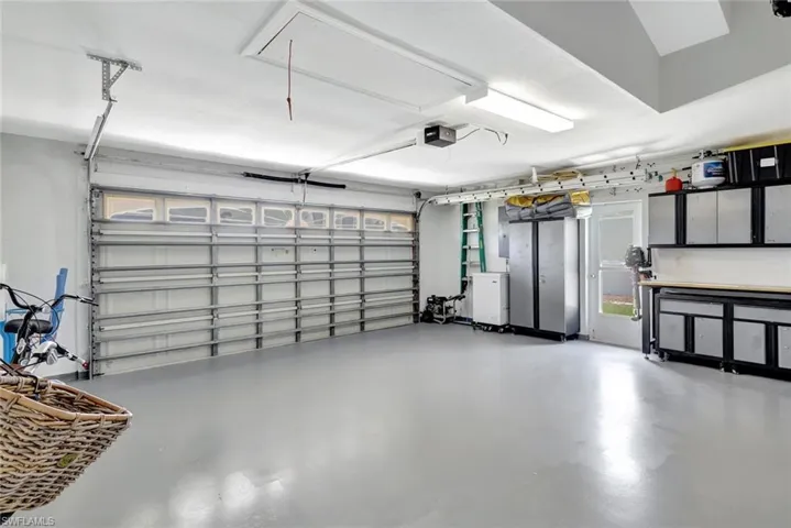 Garage with painted/epoxy floors and side access door to exterior