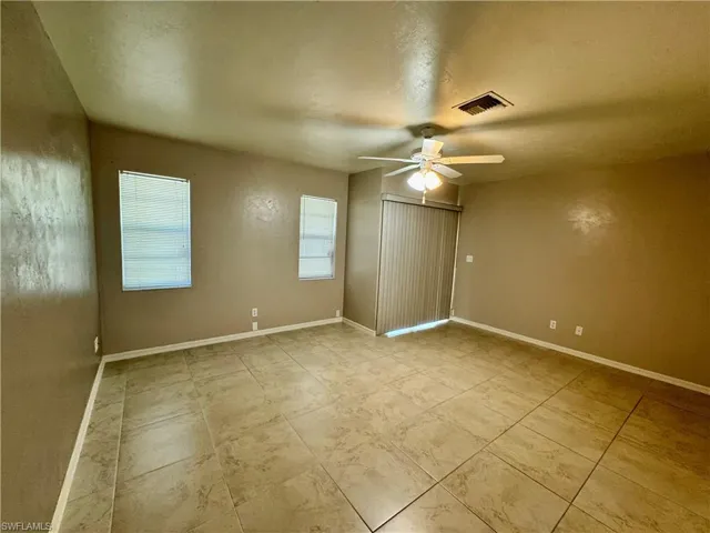 Unfurnished bedroom with a ceiling fan and a textured ceiling