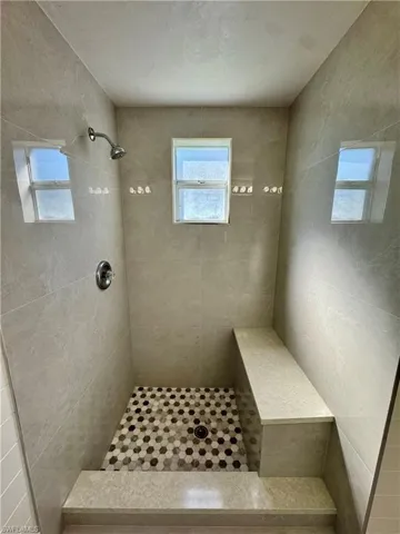 Full bathroom with tiled shower