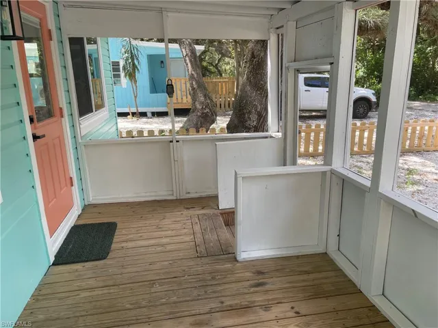 Unfurnished sunroom featuring hardwood / wood-style floors