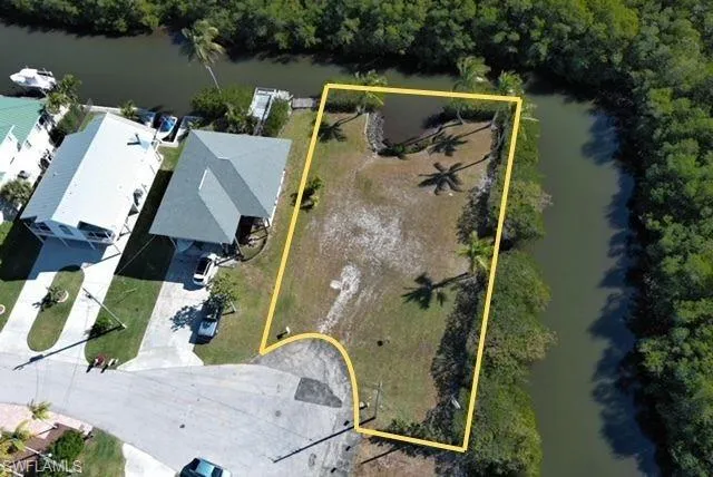 Aerial view of property's location featuring a nearby body of water and property parcel outlined