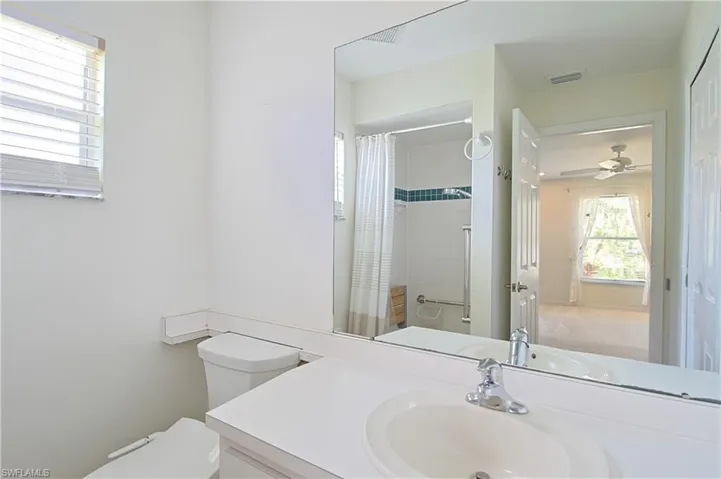 Full vanity mirror with an integrated sink and chrome faucet
