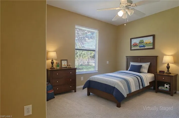 Carpeted room featuring a window with horizontal blinds, a ceiling fan with integrated lighting, and neutral wall tones