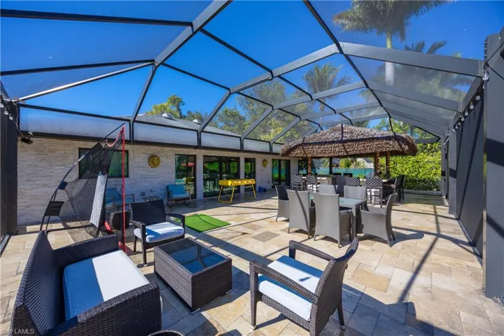 View of patio with outdoor dining area, a lanai, a sunroom, and outdoor lounge area
