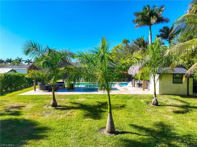 View of community with a patio, a pool, and a yard