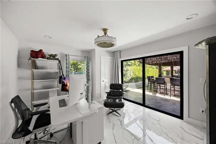 Office space featuring light marble finish floors and recessed lighting