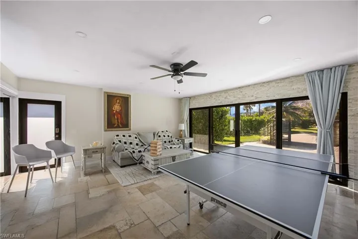 Playroom featuring stone tile flooring, a ceiling fan, and recessed lighting