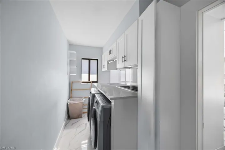 Washroom with light marble finish flooring and baseboards