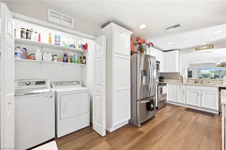 Washer and Dryer tucked away in Kitchen closet