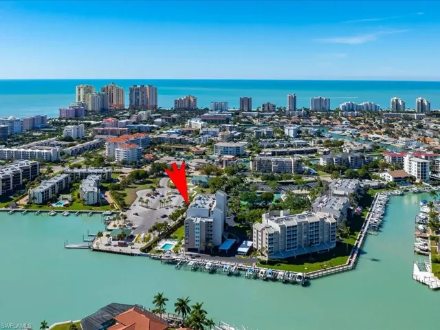 View of property location with a nearby body of water and a marina