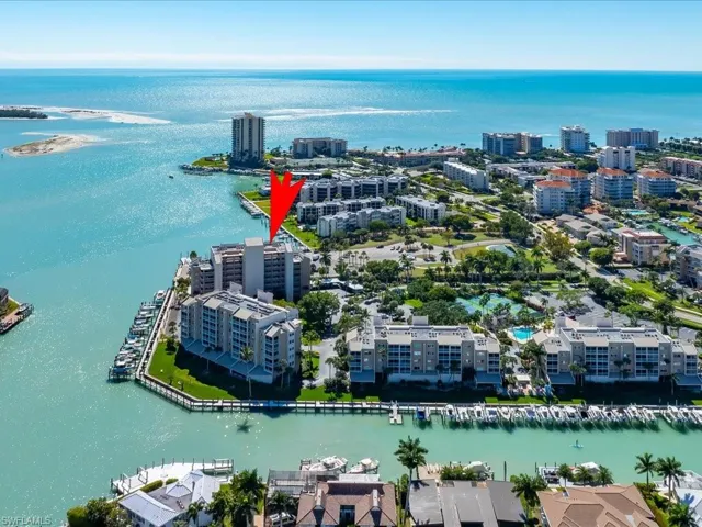 Aerial view of property and surrounding area with a nearby body of water