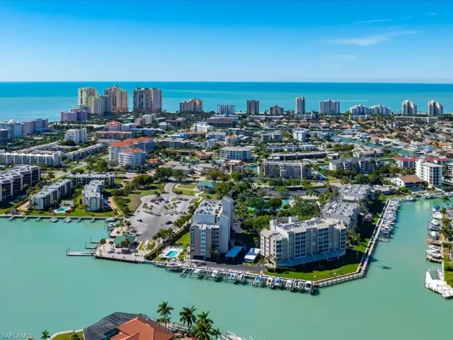 Aerial view of property's location with a large body of water and nearby urban area