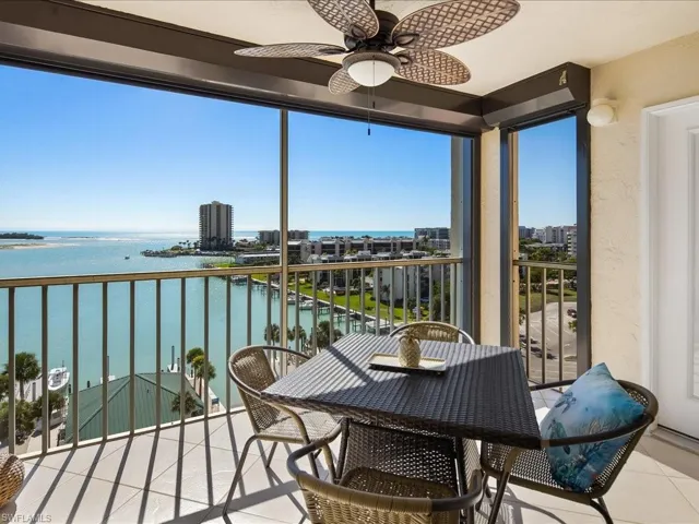 Balcony with a water view and a ceiling fan