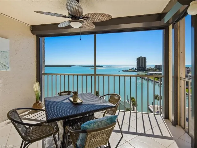 Sunroom featuring a balcony, a water view, and ceiling fan