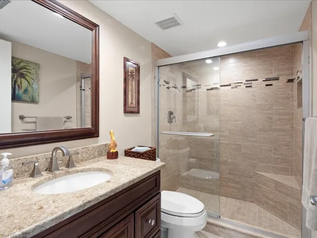 Bathroom featuring vanity and a shower stall
