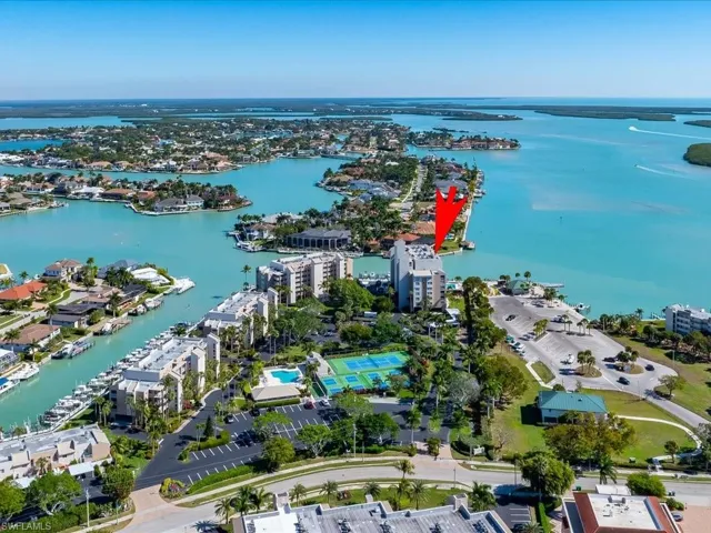 Aerial view of property and surrounding area featuring a nearby body of water