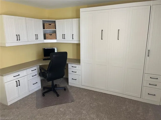 Integrated wall unit with a retractable bed and vertical paneling