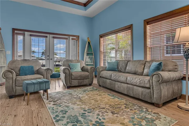 Living room with french doors and wood style finished floors