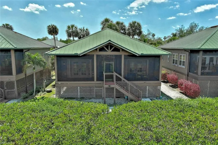 Frontof house featuring a screened patio and metal roof