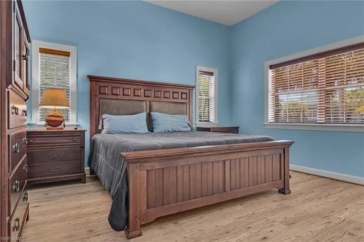Bedroom with light wood-style flooring and baseboards